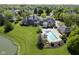 Stunning aerial view of backyard pool area near tranquil pond of luxury estate at , Carmel, IN 46032