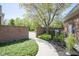Backyard with a brick wall, manicured landscaping, and a paved pathway leading to a serene outdoor space at , Carmel, IN 46032