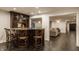 Finished basement with bar, dark wood cabinets, granite counters, and bar stool seating at , Carmel, IN 46032