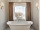 Bright bathroom features a standalone soaking tub and a large window providing an abundance of natural light at , Carmel, IN 46032