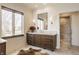 Bathroom vanity with marble countertop, wooden cabinets and decorative light fixtures at , Carmel, IN 46032