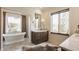 Bathroom features a soaking tub, a dual vanity with marble countertop, and plenty of natural light at , Carmel, IN 46032