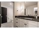 Contemporary bathroom with a vanity featuring a black countertop, white cabinets, and stylish fixtures at , Carmel, IN 46032