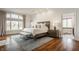 Serene bedroom with hardwood floors, large windows, and a cozy sitting area at , Carmel, IN 46032