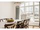 Sunlit dining room featuring a large window, chandelier, and a dining table at , Carmel, IN 46032