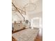 Grand foyer with a chandelier, wood floors, curved staircase, and bright natural light at , Carmel, IN 46032