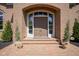 Elegant brick home entrance featuring a beautiful front door and manicured landscaping at , Carmel, IN 46032