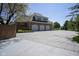 Spacious three-car garage with a large driveway and beautiful brick exterior on a sunny day at , Carmel, IN 46032