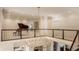 Open hallway featuring a piano, wood railings and a beautiful chandelier at , Carmel, IN 46032