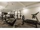 Bright home gym fully equipped with modern exercise machines and mirrored walls for a complete workout experience at , Carmel, IN 46032