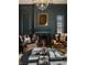 Elegant living room with dark walls, a fireplace, leather chairs, and a crystal chandelier at , Carmel, IN 46032