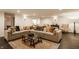 Cozy living room with an L-shaped sectional sofa, a patterned rug, decorative pillows, and stylish lighting at , Carmel, IN 46032