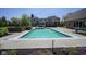 Large swimming pool with a brick border, lush greenery, and a beautiful backdrop of the home at , Carmel, IN 46032
