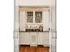 Stylish wet bar featuring glass cabinets, a sink, and sophisticated design details at , Carmel, IN 46032