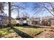 Landscaped backyard features a play structure and shed at 125 E Beverly Dr, Indianapolis, IN 46205