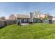 Spacious backyard with a well-maintained lawn, wooden deck, and comfortable outdoor seating at 12929 Shandon Ln, Fishers, IN 46038