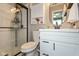 Bathroom featuring a white vanity, a modern faucet, and a tiled walk-in shower with glass door at 12929 Shandon Ln, Fishers, IN 46038