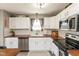 Bright kitchen with stainless steel appliances, white cabinets, tile backsplash, and wood countertops at 12929 Shandon Ln, Fishers, IN 46038