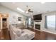Spacious living room with fireplace, vaulted ceilings, skylight, fan, and hardwood floors at 12929 Shandon Ln, Fishers, IN 46038