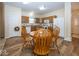 Eat-in kitchen features wood cabinets, white appliances, and wood-look flooring at 14014 Keams Dr, Fishers, IN 46038