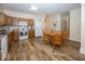 Bright kitchen featuring laminate flooring, oak cabinets, and an adjacent dining area at 14014 Keams Dr, Fishers, IN 46038