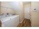 Laundry room with white washer and dryer units and wood look floors at 14014 Keams Dr, Fishers, IN 46038
