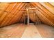 Large attic space with wood flooring, exposed beams, and natural lighting offers potential for storage or finishing at 14339 Jeremy Dr, Carmel, IN 46033