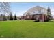 Spacious backyard featuring a well-maintained lawn, mature trees, and a glimpse of the home's exterior, perfect for outdoor activities at 14339 Jeremy Dr, Carmel, IN 46033