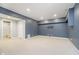 Basement featuring modern blue wall, neutral carpet, and access to the bathroom at 14339 Jeremy Dr, Carmel, IN 46033