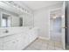 Bright bathroom featuring a double sink vanity, large mirror, and view to a bedroom at 14339 Jeremy Dr, Carmel, IN 46033