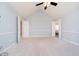 Spacious bedroom with high ceilings, neutral carpet, and a ceiling fan providing ample lighting at 14339 Jeremy Dr, Carmel, IN 46033