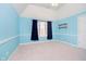 Charming bedroom with blue walls, neutral carpet, and a bright window with curtains at 14339 Jeremy Dr, Carmel, IN 46033