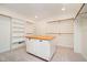 Walk-in closet featuring custom shelving, hanging rods, and a center island with a butcher block countertop at 14339 Jeremy Dr, Carmel, IN 46033