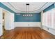 Dining room featuring hardwood floors, stylish light fixture, and modern wainscoting at 14339 Jeremy Dr, Carmel, IN 46033