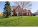 Charming two-story brick home with a manicured lawn, mature trees and a symmetrical facade create a welcoming curb appeal at 14339 Jeremy Dr, Carmel, IN 46033