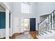 Inviting foyer with hardwood floors, staircase, and a view of the outdoors through the front door at 14339 Jeremy Dr, Carmel, IN 46033