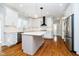 Modern kitchen featuring white cabinetry, stainless steel appliances, and hardwood floors at 14339 Jeremy Dr, Carmel, IN 46033