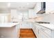 Close-up of a modern kitchen with white cabinets, an island, and hardwood floors at 14339 Jeremy Dr, Carmel, IN 46033