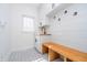 Well-lit laundry room with custom cabinets, a utility sink, and a wooden bench at 14339 Jeremy Dr, Carmel, IN 46033