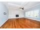 Cozy living room featuring hardwood floors, fireplace, and built-in shelving at 14339 Jeremy Dr, Carmel, IN 46033