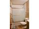 The bathroom showcases a toilet and a glass sliding shower door, offering a clean and functional space at 1508 N Woodridge Ave, Muncie, IN 47304