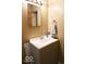 This bathroom vanity has gray cabinets, a white countertop, chrome faucet, mirror and good lighting at 1508 N Woodridge Ave, Muncie, IN 47304