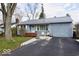 Charming single-story home featuring a metal roof, driveway, and well-manicured lawn at 1508 N Woodridge Ave, Muncie, IN 47304