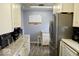 Updated kitchen with white cabinets, stainless steel refrigerator, and granite countertops at 1508 N Woodridge Ave, Muncie, IN 47304