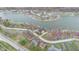 Expansive aerial view showcasing a waterfront property in a lakeside community with mature trees at 1847 Crystal Bay East Dr, Plainfield, IN 46168