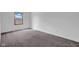 An empty bedroom with a window view and neutral gray carpeting at 1847 Crystal Bay East Dr, Plainfield, IN 46168
