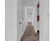 Hallway with neutral carpeting and white walls, providing access to various rooms at 1847 Crystal Bay East Dr, Plainfield, IN 46168