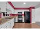 Bright kitchen with white cabinets, laminate countertops, and black appliances at 1847 Crystal Bay East Dr, Plainfield, IN 46168