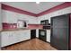 Charming kitchen with white cabinets and black appliances at 1847 Crystal Bay East Dr, Plainfield, IN 46168
