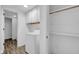A laundry room with a washer and an adjacent closet with open shelves at 1847 Crystal Bay East Dr, Plainfield, IN 46168